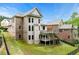 View of the house with its backyard featuring a two-story deck and lush green lawn at 5826 Sarazen Trl, Douglasville, GA 30135