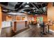 Finished basement with brick bar, white cabinets, dining area and open ceiling at 5826 Sarazen Trl, Douglasville, GA 30135