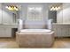 Bathroom featuring jacuzzi tub with tile surround and double sink vanities at 5826 Sarazen Trl, Douglasville, GA 30135