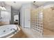 Bathroom featuring jacuzzi tub, glass blocked walk-in shower and tile floors at 5826 Sarazen Trl, Douglasville, GA 30135