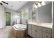 Bathroom showcasing a jacuzzi tub, double sink vanity, and tiled floors at 5826 Sarazen Trl, Douglasville, GA 30135
