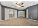 Large bedroom features gray walls, neutral carpet, with doors leading to other rooms in the home at 5826 Sarazen Trl, Douglasville, GA 30135
