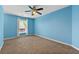 Bedroom with neutral carpet, a ceiling fan, and a window providing ample natural light at 5826 Sarazen Trl, Douglasville, GA 30135