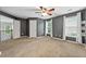 Spacious bedroom with gray walls, large windows, and a ceiling fan offers comfort and style at 5826 Sarazen Trl, Douglasville, GA 30135
