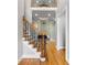 Open foyer with wooden staircase, hardwood floors, and view into the bright living room at 5826 Sarazen Trl, Douglasville, GA 30135