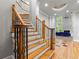 Elegant foyer with wooden staircase and hardwood floors flowing into the spacious living room at 5826 Sarazen Trl, Douglasville, GA 30135