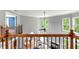 Bright foyer boasts wood railing, with views of the living room and natural light at 5826 Sarazen Trl, Douglasville, GA 30135