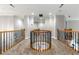 Spacious upstairs hallway featuring wood and wrought iron railing around an open stairwell at 5826 Sarazen Trl, Douglasville, GA 30135