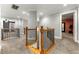 Hallway with neutral paint, decorative railing, and carpet flooring leading to multiple rooms at 5826 Sarazen Trl, Douglasville, GA 30135