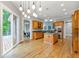 Bright and airy kitchen featuring an island cooktop, stainless steel appliances, and access to the deck at 5826 Sarazen Trl, Douglasville, GA 30135