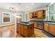 Stylish kitchen featuring stainless steel appliances, center island cooktop, and easy access to the patio at 5826 Sarazen Trl, Douglasville, GA 30135