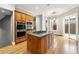 Well-lit kitchen with center island cooktop, modern appliances, and access to both the dining and living area at 5826 Sarazen Trl, Douglasville, GA 30135