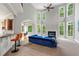 Bright living room with soaring ceilings, large windows, fireplace, and stylish blue sofa at 5826 Sarazen Trl, Douglasville, GA 30135