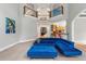 Bright living room boasting a soaring ceiling, balcony overlook, and plush blue sectional sofa at 5826 Sarazen Trl, Douglasville, GA 30135