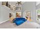 Bright living room with soaring ceiling, balcony overlook, plush blue sectional, and elegant gray walls at 5826 Sarazen Trl, Douglasville, GA 30135