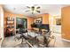 Bright home office featuring a ceiling fan, ample workspace, and natural light from double doors at 5826 Sarazen Trl, Douglasville, GA 30135