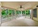 Screened-in porch with ceiling fan and wooded view at 5826 Sarazen Trl, Douglasville, GA 30135
