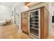 Chic bar area with wood cabinetry, drawers, countertop, and sleek beverage cooler for entertaining guests at 1042 Oakdale Se Dr, Smyrna, GA 30080