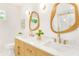 Double sink bathroom features a modern design with unique mirrors and stone countertops at 1042 Oakdale Se Dr, Smyrna, GA 30080