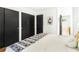 Bright bedroom showcasing a comfortable bed and minimalist decor with modern black closet doors at 1042 Oakdale Se Dr, Smyrna, GA 30080