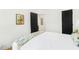 Bright bedroom featuring a comfortable bed and white walls with black doors and modern decor at 1042 Oakdale Se Dr, Smyrna, GA 30080