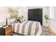 Stylish bedroom with a comfortable bed, patterned rug, and ample closet space with sliding doors at 1042 Oakdale Se Dr, Smyrna, GA 30080