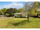 Charming home with a well-maintained lawn and mature trees creating a serene outdoor setting at 1042 Oakdale Se Dr, Smyrna, GA 30080