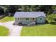Aerial view of renovated one-story home featuring lovely lawn and landscaping at 1042 Oakdale Se Dr, Smyrna, GA 30080