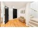Bright hallway with hardwood floors, black doors, and stairs leading to another level at 1042 Oakdale Se Dr, Smyrna, GA 30080