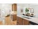 Bright open-concept kitchen and dining area featuring stainless steel appliances, quartz counters and hardwood floors at 1042 Oakdale Se Dr, Smyrna, GA 30080