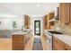Modern kitchen featuring natural wood cabinets, a white quartz countertop, and stainless steel appliances at 1042 Oakdale Se Dr, Smyrna, GA 30080
