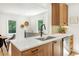 Open-concept kitchen boasts a quartz countertop island, stainless steel appliances, and modern finishes at 1042 Oakdale Se Dr, Smyrna, GA 30080