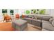 Spacious living room with a large sectional sofa, accent chairs, and leafy wall art at 1042 Oakdale Se Dr, Smyrna, GA 30080