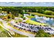 A scenic aerial view of golf course and clubhouse situated by a serene lake with lush trees at 210 Creekside Overlook, Hiram, GA 30141