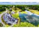 Overhead image shows a golf course clubhouse with parking and a lake, surrounded by lush greenery at 210 Creekside Overlook, Hiram, GA 30141