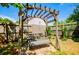 Peaceful wooden swing under a pergola offering relaxation in a private backyard at 210 Creekside Overlook, Hiram, GA 30141