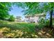 Large, lush backyard with mature trees, outdoor furniture, and a well-kept lawn at 210 Creekside Overlook, Hiram, GA 30141