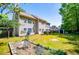 Expansive backyard featuring a spacious lawn, patio with seating, and mature trees at 210 Creekside Overlook, Hiram, GA 30141