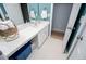 Bathroom featuring a white vanity sink with chrome faucet, under vanity storage, and a large mirror at 210 Creekside Overlook, Hiram, GA 30141