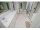 Bright bathroom featuring a double sink vanity, shower, tub and neutral tones at 210 Creekside Overlook, Hiram, GA 30141