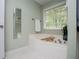 This bathroom features a relaxing soaking tub next to a large sunny window at 210 Creekside Overlook, Hiram, GA 30141