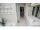 Bright bathroom featuring a double sink vanity and closet at 210 Creekside Overlook, Hiram, GA 30141