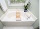 A luxurious soaking tub is situated next to a window at 210 Creekside Overlook, Hiram, GA 30141