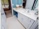Bathroom featuring a white vanity sink with chrome faucet, under vanity storage, and a large mirror at 210 Creekside Overlook, Hiram, GA 30141
