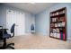 Carpeted bedroom with closet, blue walls and a bookcase at 210 Creekside Overlook, Hiram, GA 30141