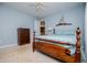 Relaxing bedroom with blue walls, wood bed frame, dresser and ceiling fan at 210 Creekside Overlook, Hiram, GA 30141
