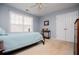 This bedroom features blue walls, a bed with a wood frame, and a ceiling fan at 210 Creekside Overlook, Hiram, GA 30141