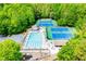 Overhead shot of community pool and tennis courts with ample lounge seating surrounded by trees at 210 Creekside Overlook, Hiram, GA 30141