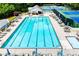 A spacious community pool with lounge chairs and umbrellas around it, a great place to relax at 210 Creekside Overlook, Hiram, GA 30141