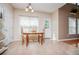 Dining room with kitchen view, tile floor, wooden table and chairs, and lots of sunlight at 210 Creekside Overlook, Hiram, GA 30141